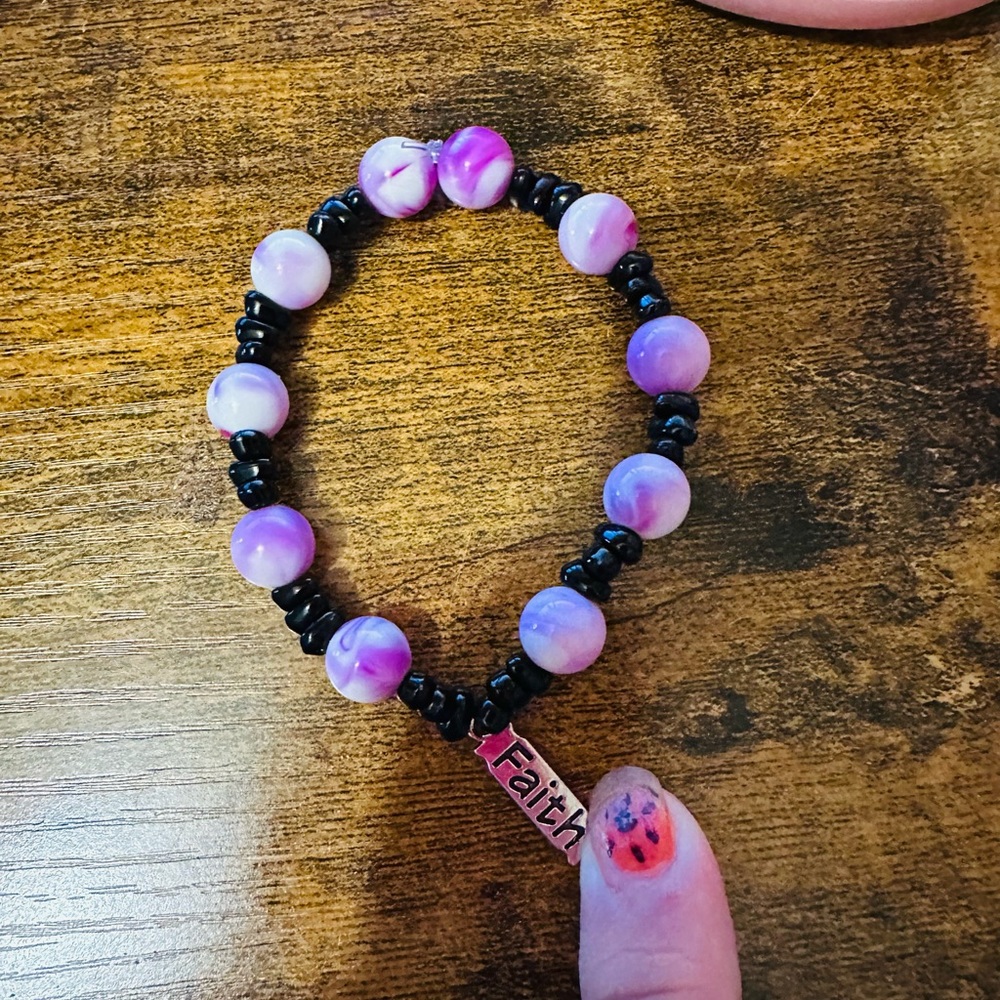 Black and purple bracelet with faith charm